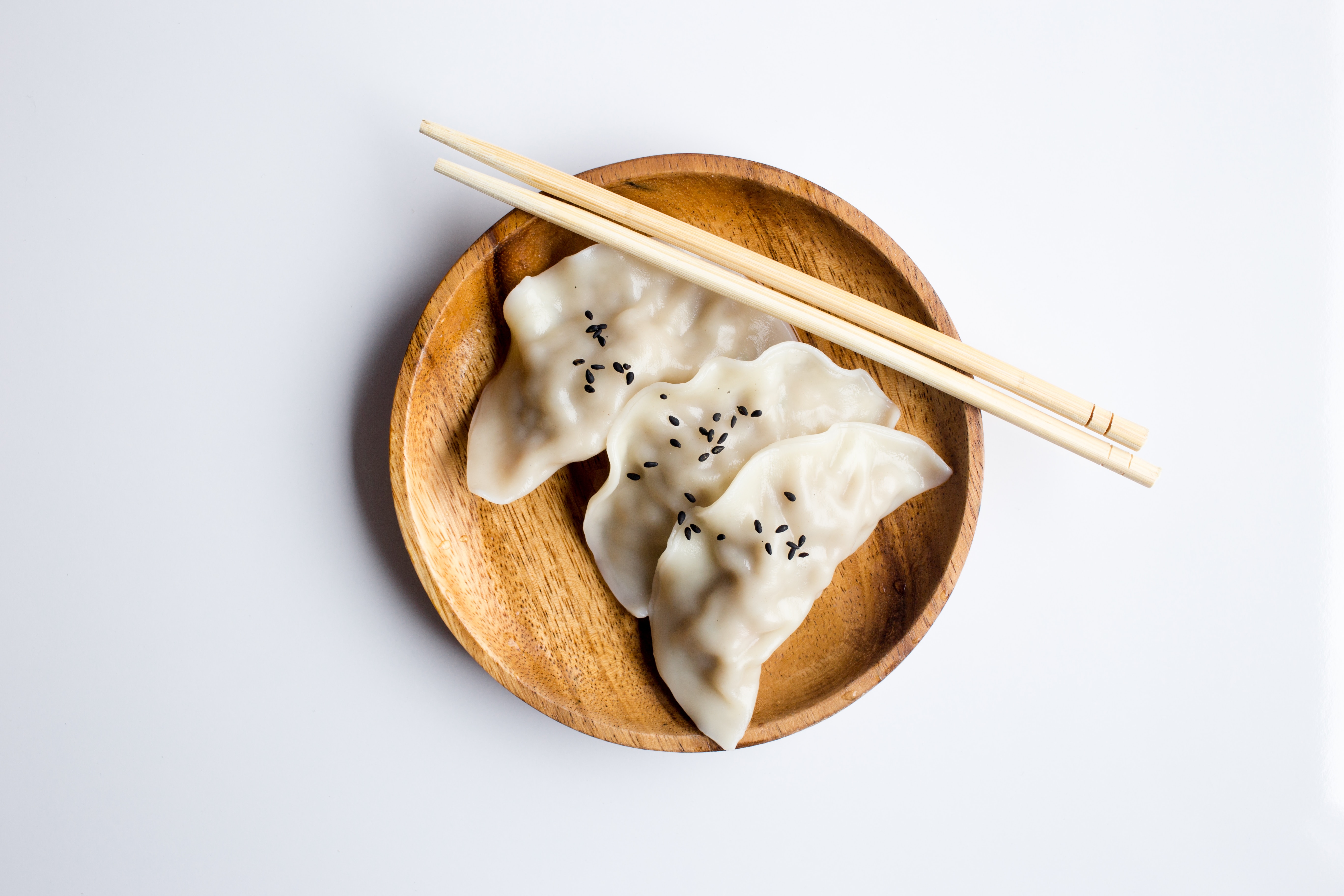 three white dimsum on wood bowl