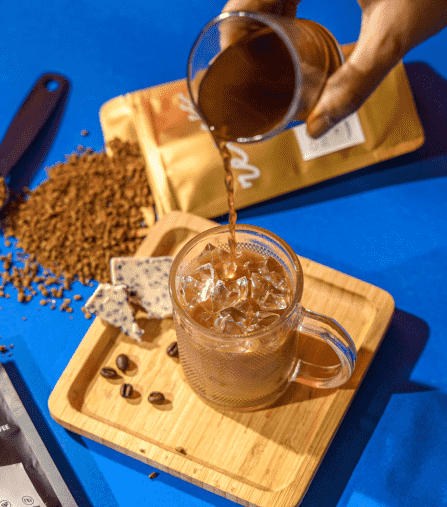 cold coffee in a glass jug at wood bowl